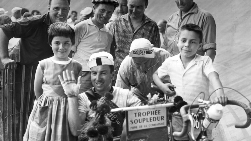 Irish cyclist Seamus ‘Shay’ Elliott (1934 - 1971) takes a ride in a pram after arriving at Toulouse during the Tour de France in July 1961. Photograph:  Keystone/Getty Images