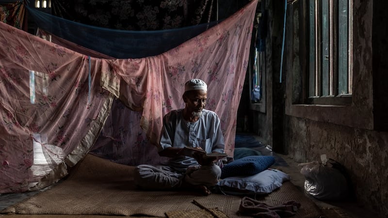 A Rohingya Muslim reads from the Quran in one of the few undamaged mosques in Maungdaw, Myanmar. Photograph: Adam Dean/New York Times