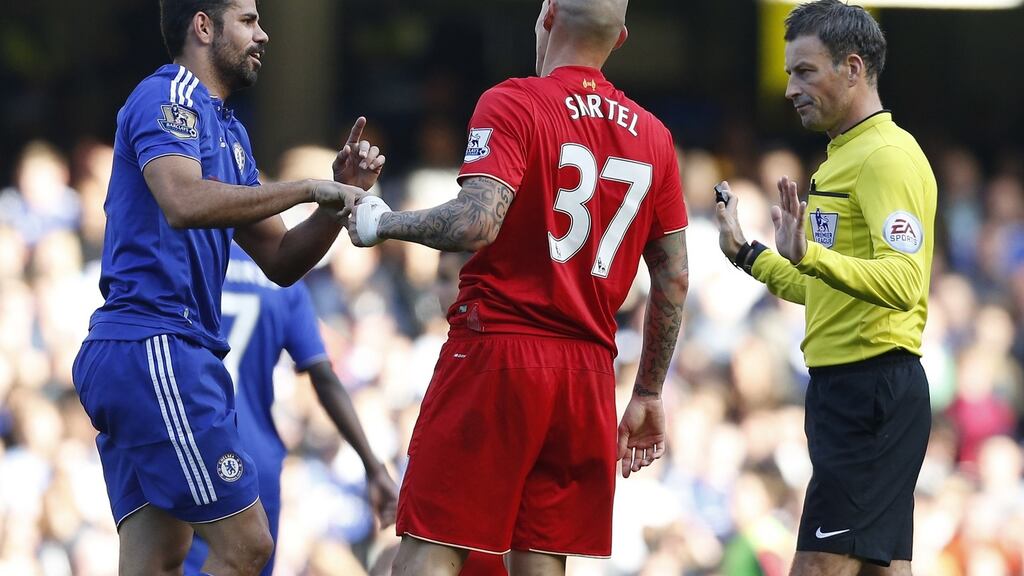 Referee Mark Clattenburg talks to Chelseas Brazilian-born Spanish striker Diego Costa and Liverpool’s Martin Skrtel. Photograph: Getty Images
