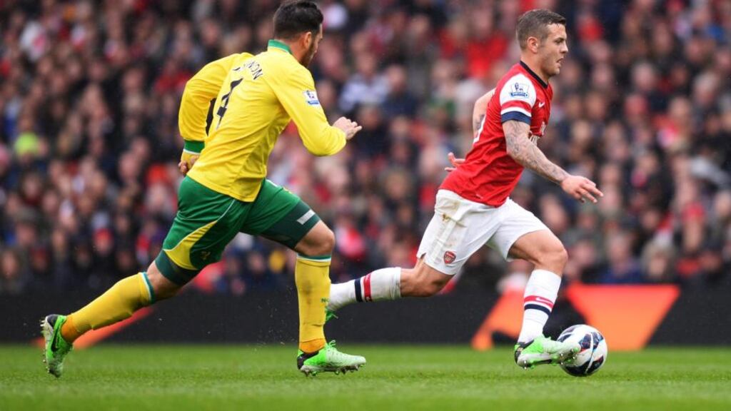Bradley Johnson (Norwich City) competes for the ball against Jack Wilshere (Arsenal) during the Barclays Premier League match at Emirates Stadium. Photograph: Mike Hewitt/Getty Images
