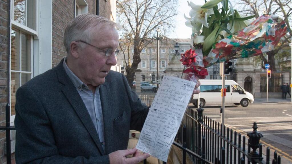 Lord Mayor of Dublin Christy Burke looks at flowers and messages left at the scene where a homless man died on Molesworth St in Dublin this week. Photograph: Collins