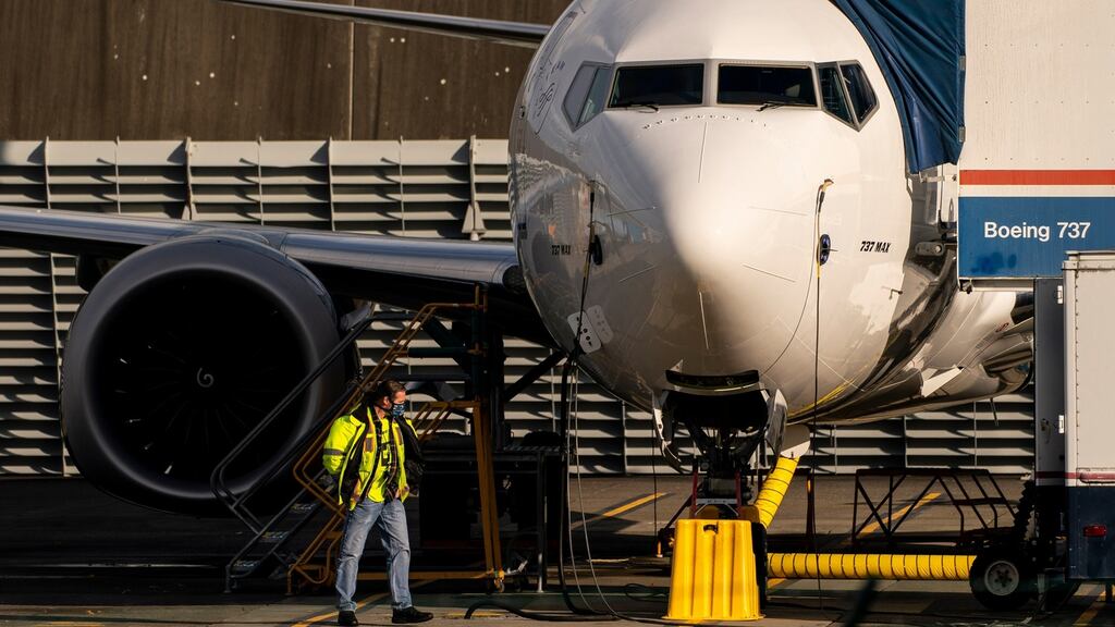 A worker beside a Boeing 737 Max aircraft parked at the company’s Renton production facility in Washington. Photograph: David Ryder/Getty Images