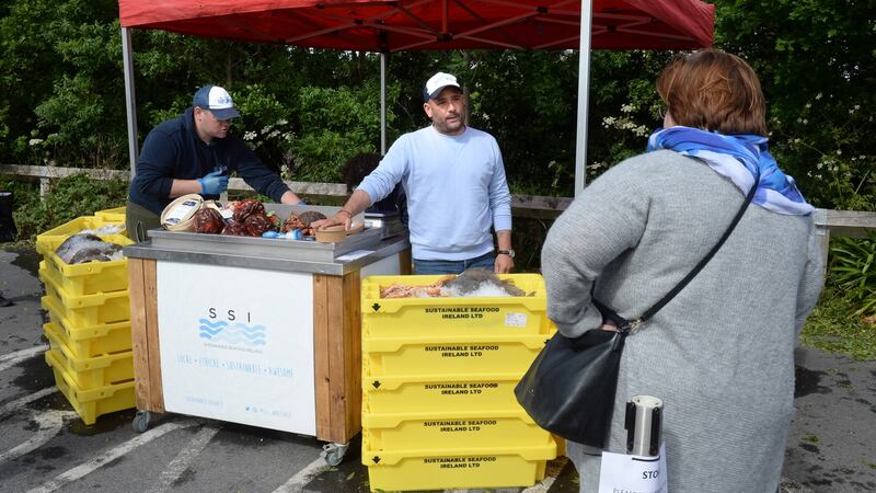 Niall Sabongi, centre, of Sustainable Seafood Ireland, at a market at Airfield Estate, Dundrum, Dublin. Photograph: Dara Mac Dónaill
