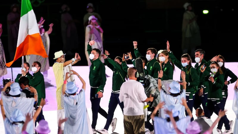 Kellie Harrington and Brendan Irvine lead Team Ireland while holding the tricolour. Photograph: James Crombie/Inpho