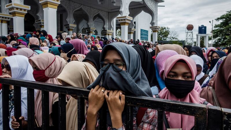 People watch a public caning for violations against Sharia law at Syuhada mosque in Banda Aceh, Indonesia. Photograph: Ulet Ifansasti/Getty Images