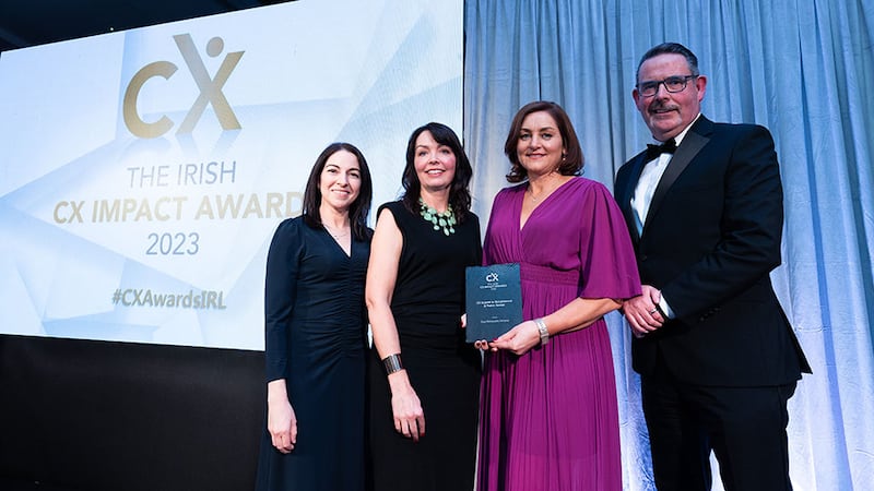 Jenny McCoy, awards judge, presents the CX impact in government & public sector award to the Gas Networks Ireland team.