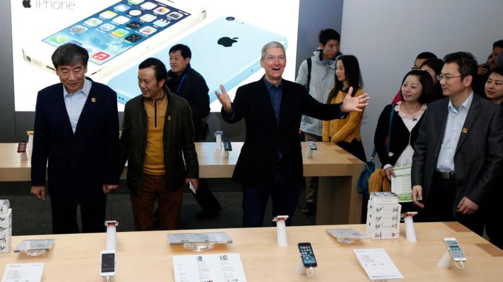 Apple chief executive Tim Cook celebrates the launch of the iPhone on China’s Mobile’s network in Beijing. Photograph: Kim Kyung-Hoon/ Reuters
