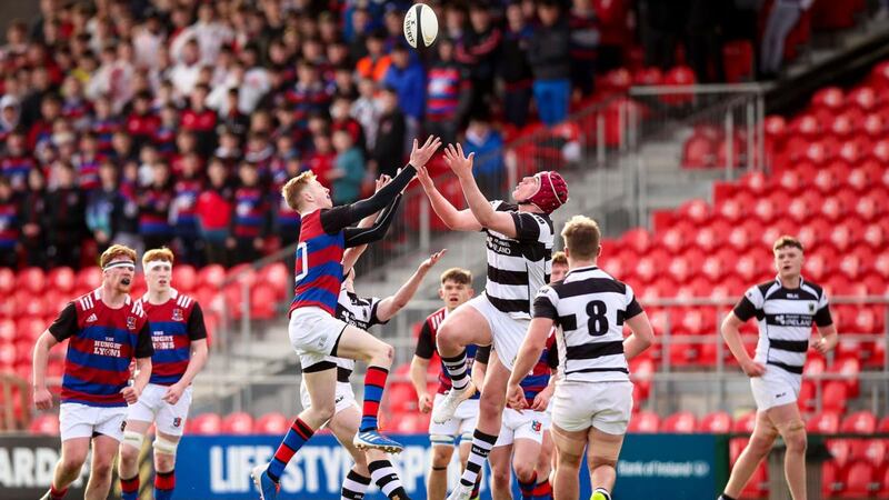 St. Munchin’s Alex Wood goes up for the ball with Darragh McSweeney of PBC during the Clayton Hotels Munster Schools Senior Cup semi-final at Musgrave Park. Photograph: Tommy Dickson/Inpho