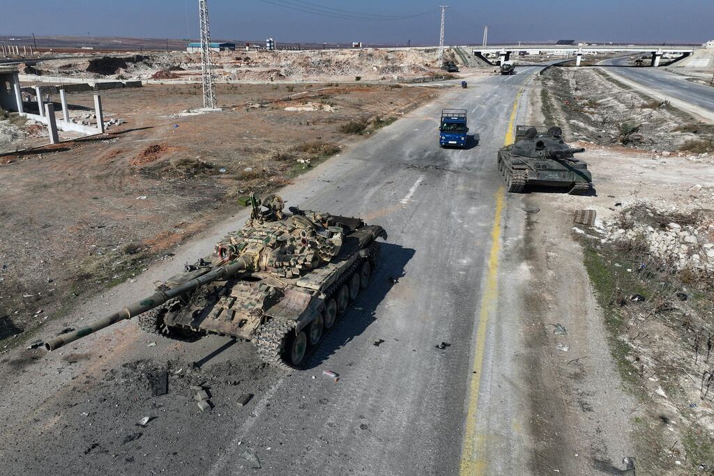 A car drives past Syrian army equipment that was abandoned on the highway to Damascus, near the town of Suran, north of Hama city on December 3rd. Photograph: Omar Haj Kadour/AFP via Getty