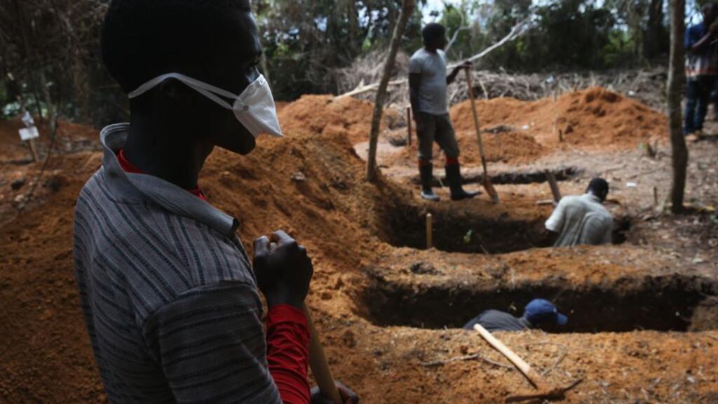 Grave diggers prepare for new Ebola victims outside an Ebola treatment centre near Gbarnga, in Bong County in central Liberia Photograph: John Moore. Getty Images.