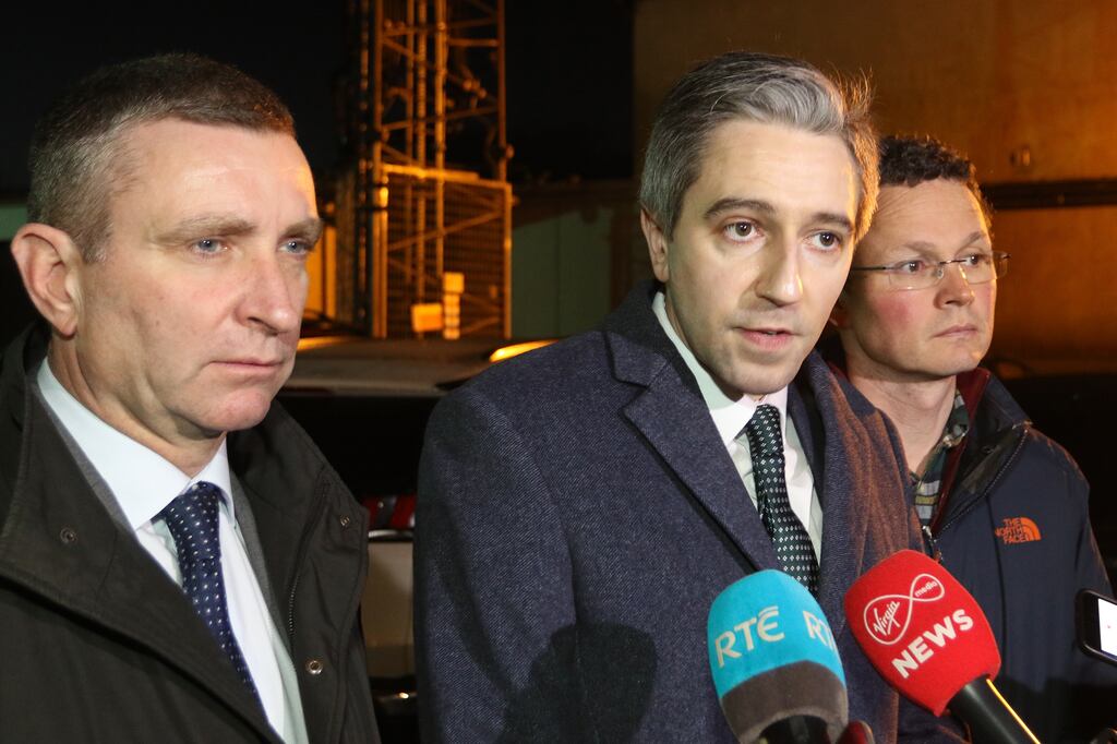 Acting Minister for Justice Simon Harris with Niall Collins TD, left, and Patrick O'Donovan TD, right, at the press conference after visiting Rathkeale. Photograph: Brendan Gleeson