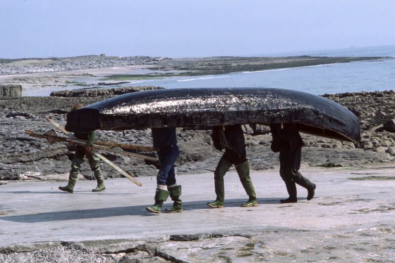 Seamen carry their currach on Inishmaan, May 1984. Photograph: Gérard Sioen/Gamma-Rapho/Getty