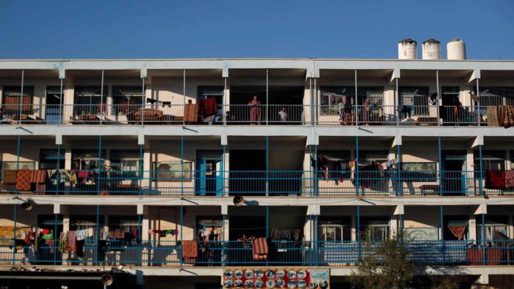 Palestinians watch a party for a bride ahead of her wedding ceremony at a United Nations-run school sheltering displaced Palestinians from the Israeli offensive, in Beit Lahiya town in the northern Gaza Strip today. Phogoraph: Suhaib Salem/Reuters