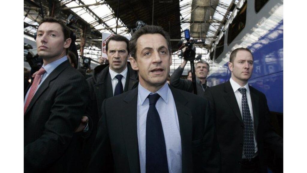 France's UMP party presidential candidate Nicolas Sarkozy
arrives at Paris's Gare de Lyon train station yesterday, after
stepping down as interior minister to focus on his election
campaign.