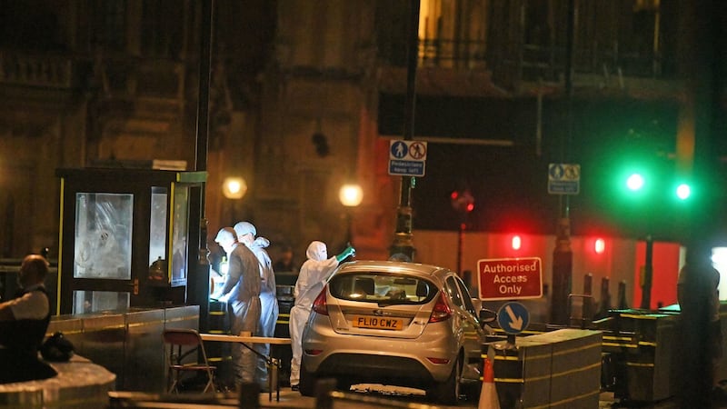 Forensic officers by the car that crashed into security barriers outside the Houses of Parliament in Westminster, London, on Tuesday. Photograph: Victoria Jones/PA Wire