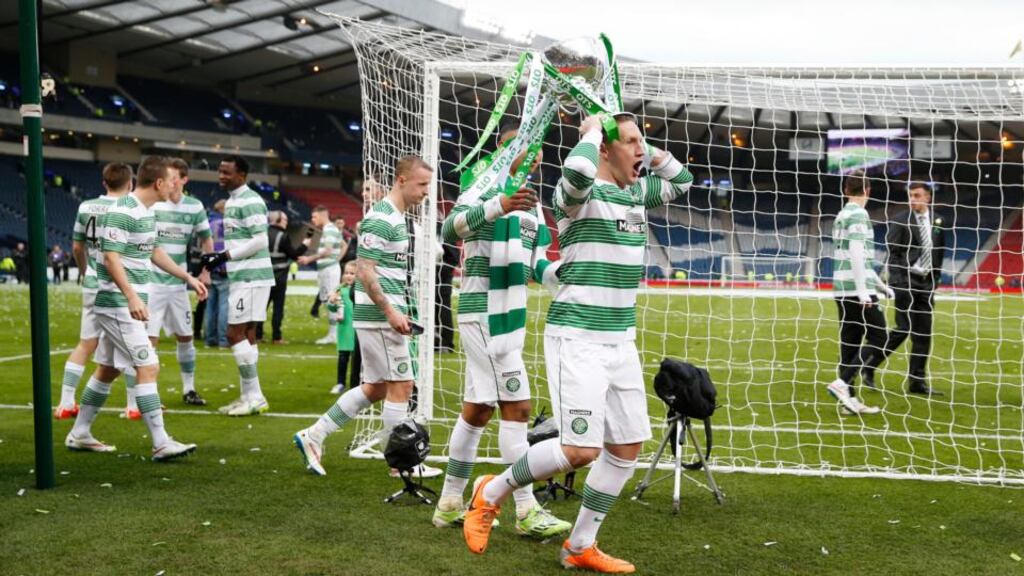 Celtic’s Kris Commons celebrates with the trophy after winning the Scottish League Cup Final. Photograph: Lee Smith/Reuters