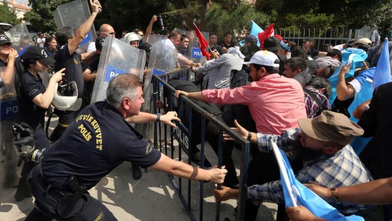 Riot police clash with a group of Uighur protesters outside the Chinese Embassy in Ankara, Turkey, in June 2015. Photograph: Burhan Ozbilici/AP