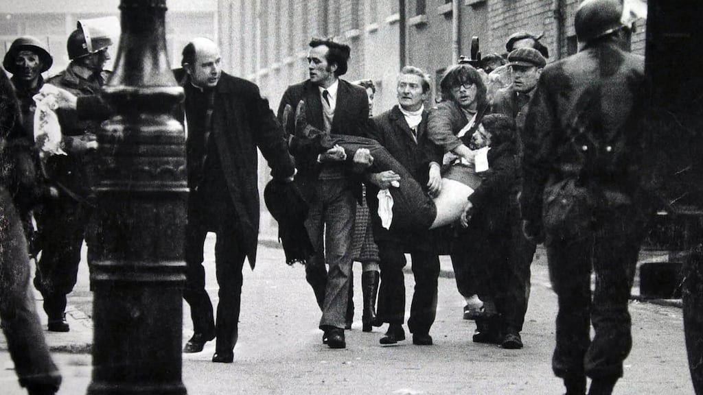 Bishop Edward Daly carries a blood stained handkerchief ahead of the body of Jack Duddy, who was shot dead in Derry on Bloody Sunday. Photograph: Stanley Matchett