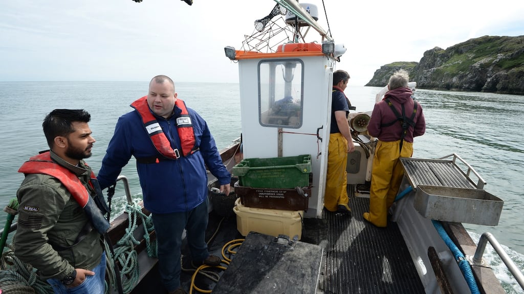 Gareth ‘Gaz’ Smith, second from left, chef owner at Michael’s of Mount Merrion, with  manager Talha Pasha and  fishermen Steven Farren and Robert Markey on board Celtic Spirit II, off Howth, Co Dublin. Photograph: Dara Mac Dónaill