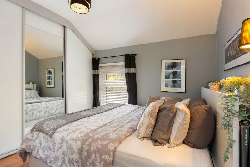 On the first floor, the main bedroom is to the front with built-in sliding-door wardrobes.