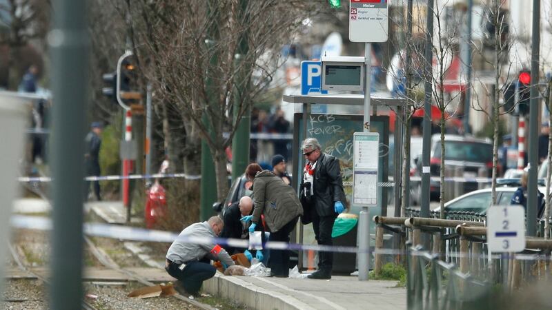 Investigators collect evidence near a tram track in Schaerbeek, Belgium, Friday March 25, 2016. A witness speaking on Belgian state broadcaster RTBF described hearing two blasts and shots from heavy weapons during the police raid on the Schaerbeek neighborhood. Photograph: Alastair Grant/AP