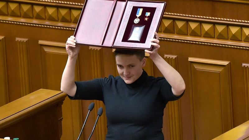 Nadiya Savchenko holds her “Hero of Ukraine” medal during the sitting of Ukraine’s parliament in Kiev on Thursday, during which she was stripped of her immunity. Photograph: Sergei Supinsky/AFP/Getty Images