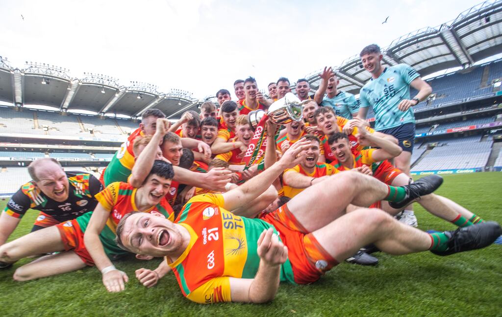 Carlow's John Michael Nolan leads the celebrations as the team celebrates with the McDonagh Cup. Photograph: Tom Maher/Inpho