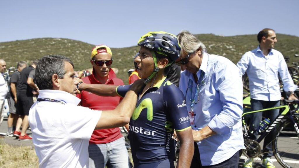 Nairo Quintana of Movistar is helped after falling during the 11th stage of the Vuelta a Espana race. The Colombia rider was forced to abandon the race after fracturing a shoulder blade. Photograph: Javier Lizon/EPA