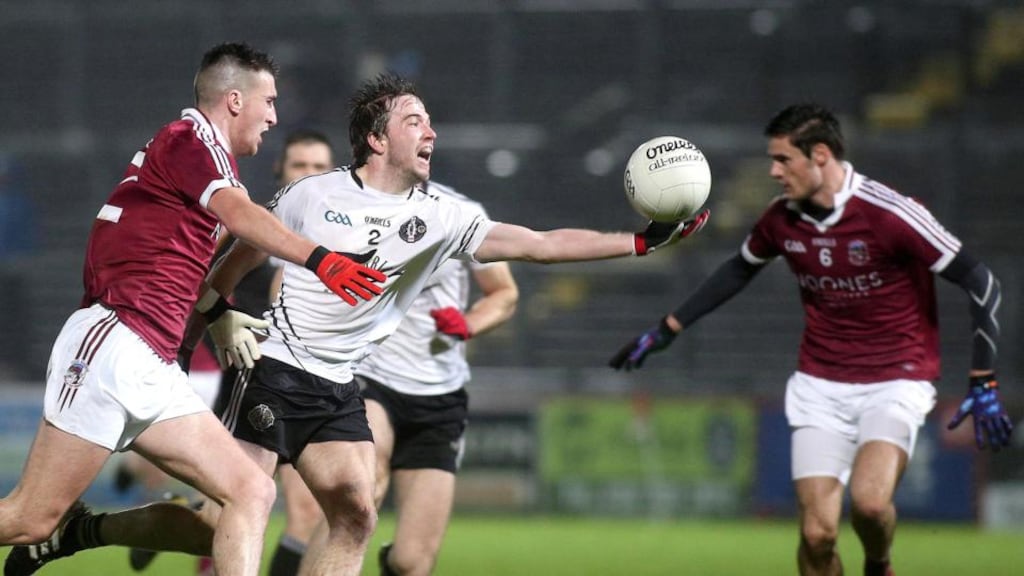 Omagh’s Gregory Murray is challenged by Slaughtneil’s Meehaul McGrath. Photograph: Lorcan Doherty/Inpho