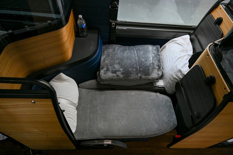 A suite, which comes with two seats that fold into a flat bed that has a foam mattress, sheet, pillow and plush blanket, on a Napaway sleeper coach. Photograph: Kenny Holston/The New York Times