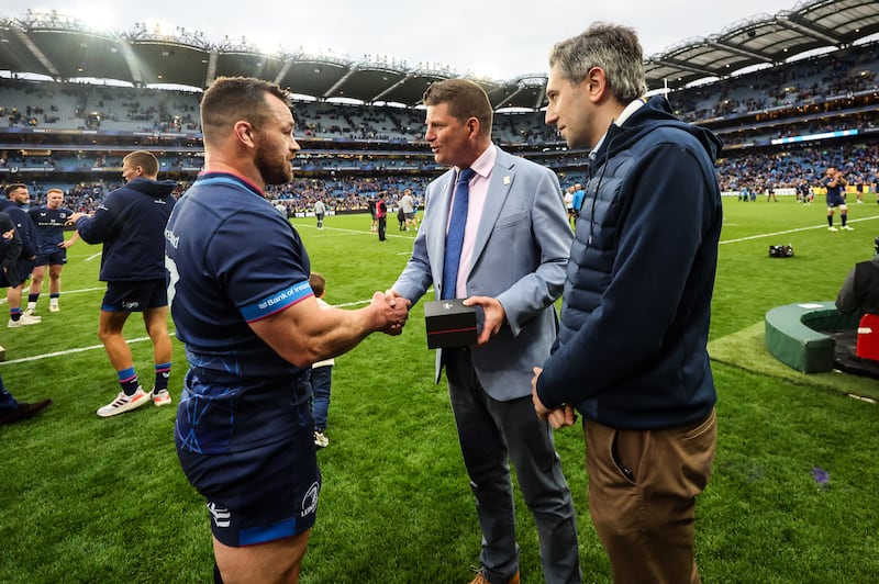 Leinster’s Cian Healy is presented with an award from EPCR chairman Dominic McKay and Taoiseach Simon Harris after making the most Champion Cup appearances with his role in Leinster's victory over Northampton Saints at Croke Park. Photograph; James Crombie/Inpho