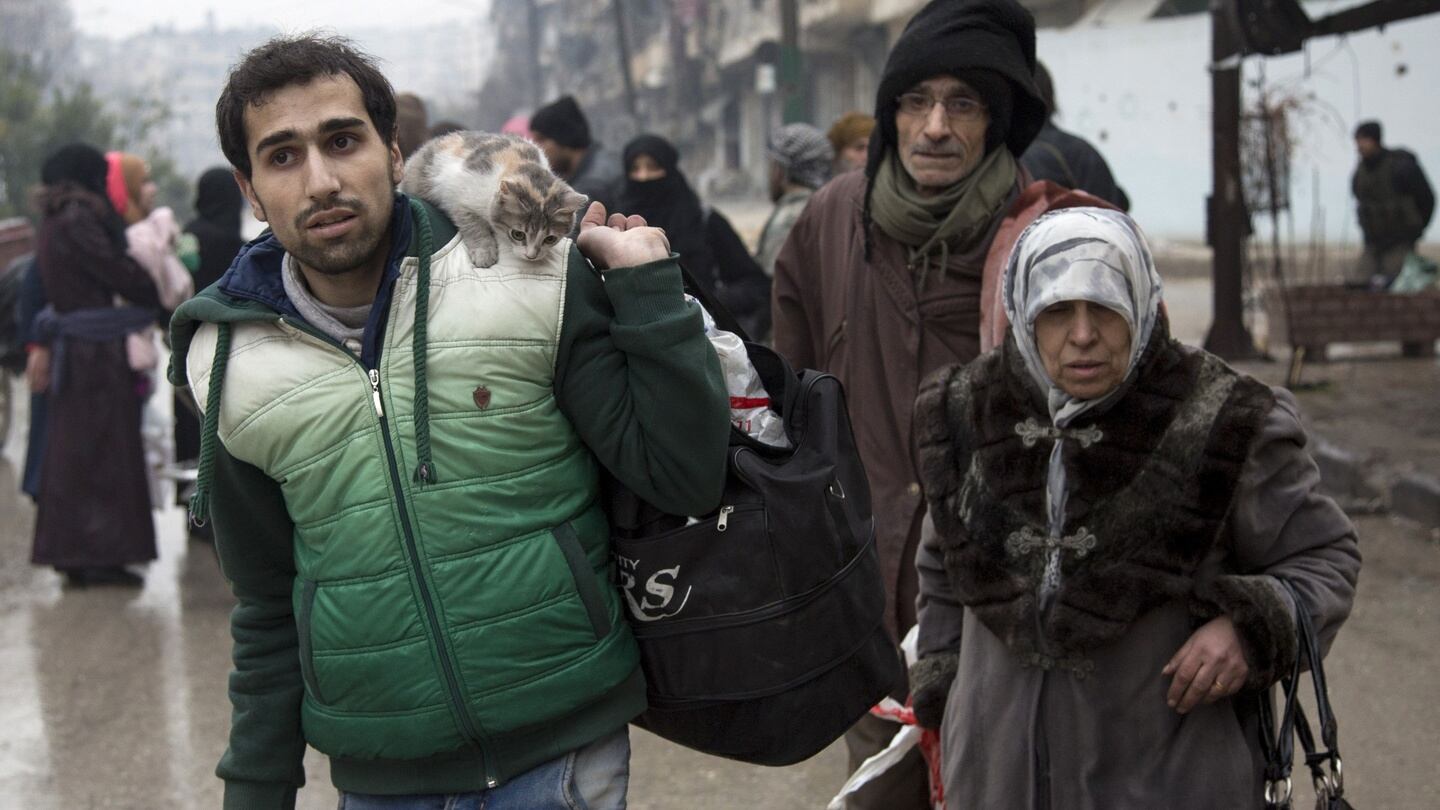 Syrians leave a rebel-held area of Aleppo towards the government-held side on Tuesday. Photograph: Getty Images