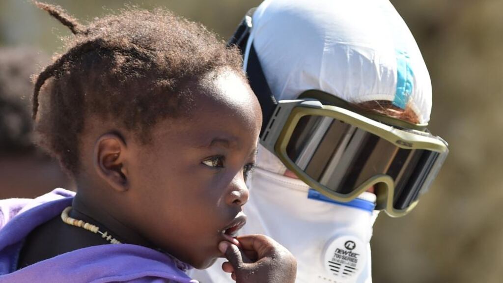 A crew member of the Irish Navy vessel LE Niamh holds a baby who was rescued last month. Photograph: Carmelo Imbesi/AP Photo