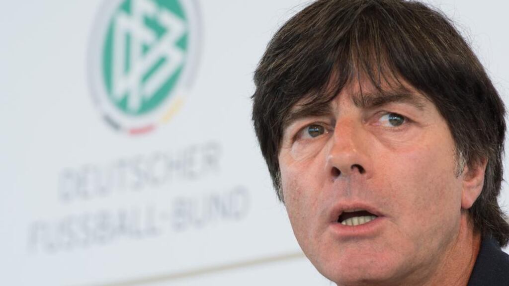Mesut Ozil poses in his new Arsenal shirt in Munich yesterday. Germany coach Joachim Löw has criticised Real Madrid for selling the midfield play-maker. Photograph: Stuart MacFarlane/Getty Images.