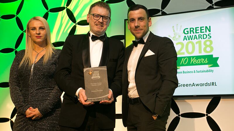 Eoin, Lonergan, Director, Performance Improvement Advisory, EY presents The Green Energy Provider Award to Jagoda Moore & Gareth Hamilton, Thorntons Recycling.