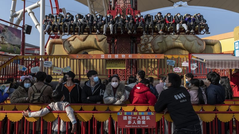 Patrons queue for a ride at the Happy Valley park in Wuhan on January 2nd. Photograph: Gilles Sabrie/The NewYork Times