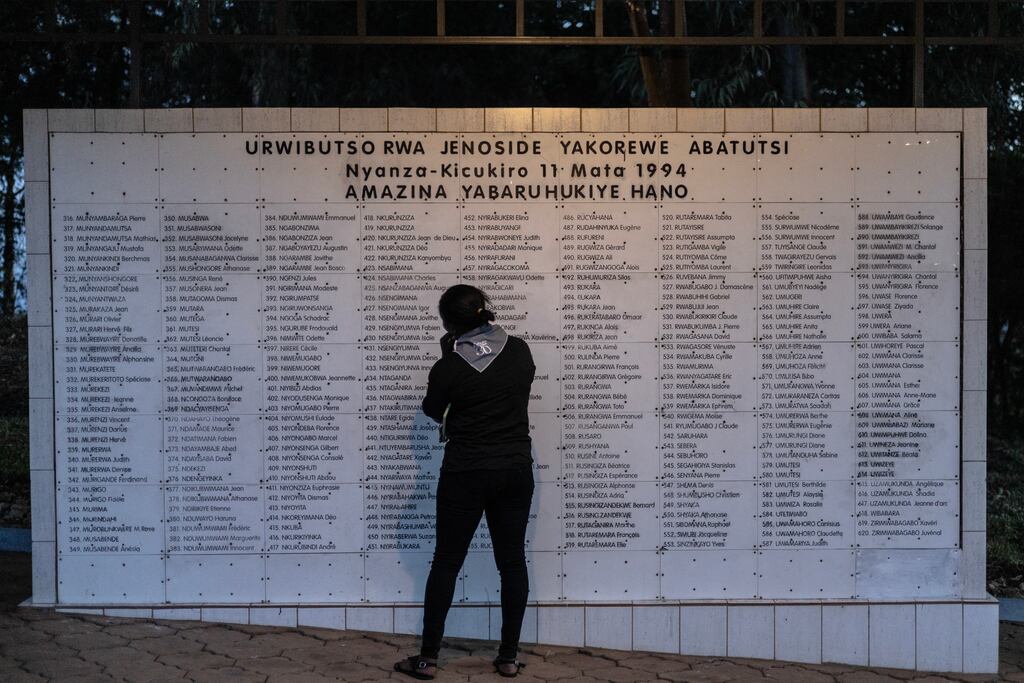 A woman stands in front of list of names of people killed during the 1994 Genocide in Kigali in April 2024. Photograph: Guillem Sartorio/AFP via Getty Images