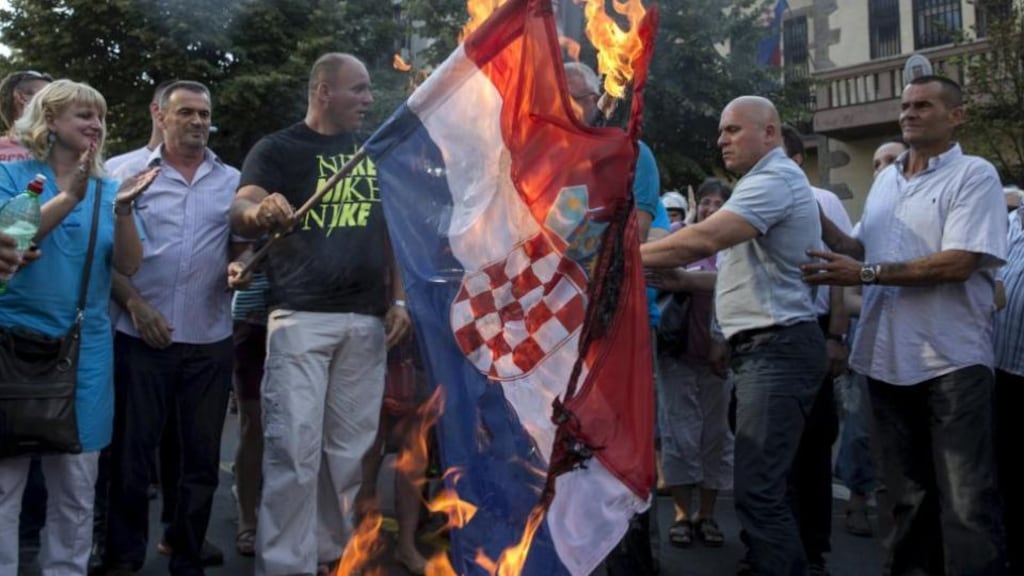 Serbian nationalist leader Vojislav Seselj (behind the flag) and his party members burn the Croatian national flag in front of the Croatian embassy during a protest marking the 20th anniversary of Croatia’s four-day Operation Storm. Photograph: Marko Djurica/Reuters