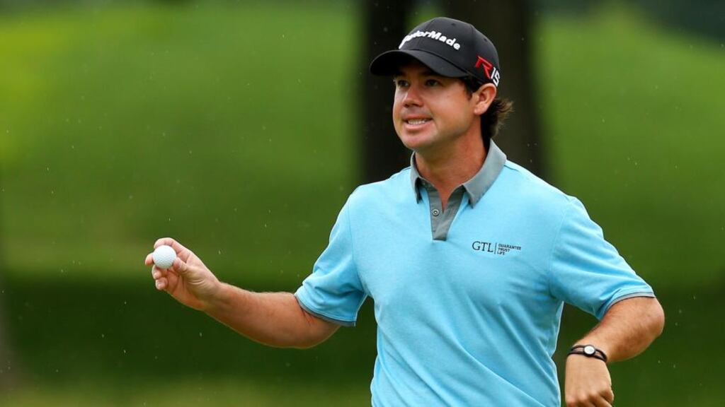 Brian Harman holds up his ball after putting on the eighth green during the third round of the Travelers Championship at TPC River Highlands  in Cromwell, Connecticut. Photograph: Jim Rogash/Getty Images