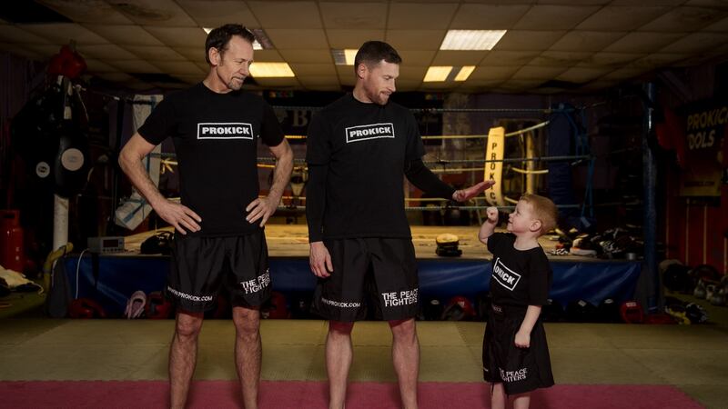 Billy Murray  with amateur world k1 kickboxing champion Johnny Smith  and Leo Smith (4) who is Billy’s grandson, and Johnny’s son  at Prokick Gym in Belfast. Photograph:  Liam McBurney