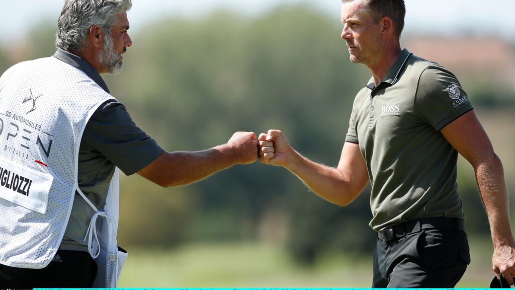 Henrik Stenson of bumps fists with Guido Migliozzi’s caddie on the ninth hole during day one of the Italian Open. Photograph: Luke Walker/Getty Images