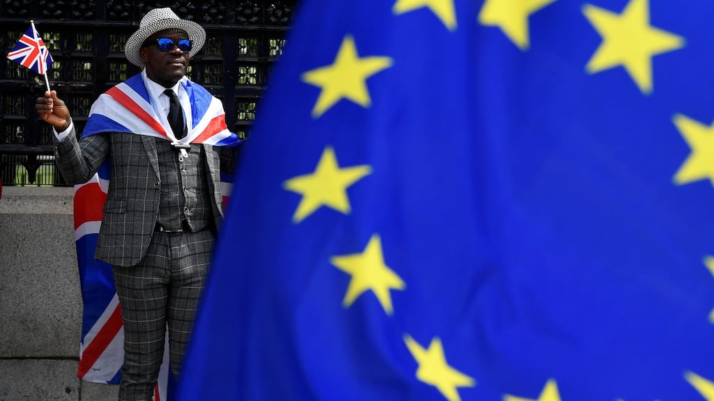 A file image of a pro-Brexit protester stands behind an EU flag outside the Houses of Parliament in London. Photograph: Reuters
