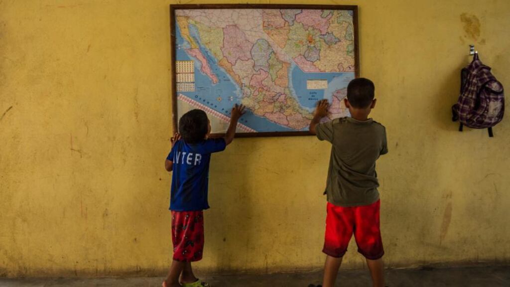 Undocumented migrant children look at a map of Mexico at the La 72 shelter in Tenosique, Mexico. Photograph: Meridith Kohut/The New York Times
