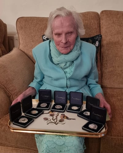 Sarah Coyle with the presidential medals she has received since turning 100. Photograph: Family photo