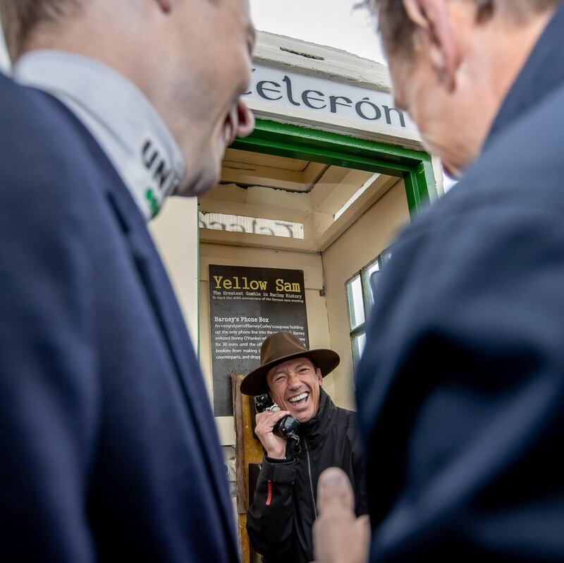 Frankie Dettori in the phone box at Bellewstown Racecourse last month. He was auctioning off Barney Curley’s fedora. Photograph: Morgan Treacy/Inpho