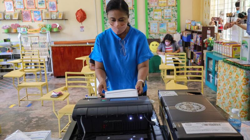 Vice-president Leni Robredo casts her ballot at an elementary school turned into a voting precinct in Naga city, Philippines. Photograph: EPA/OSMP