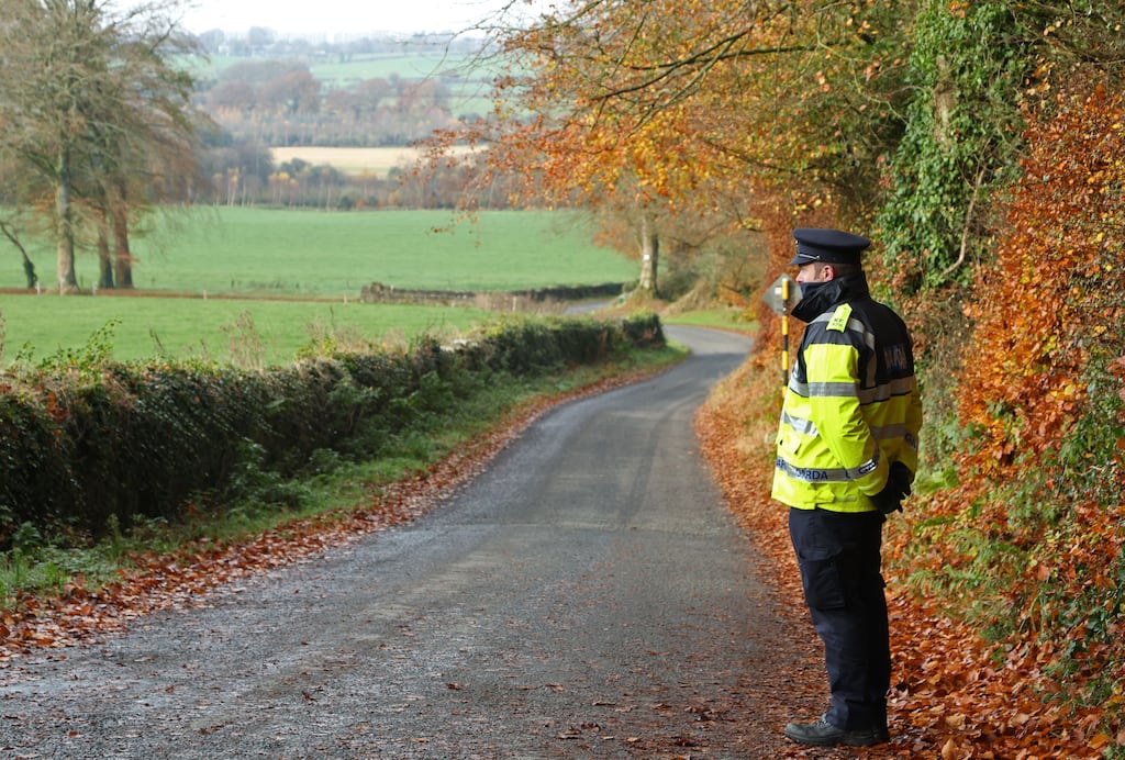 A garda on duty at a sealed-off access route in an area around Grangecon in Co. Wicklow, where searches are continuing in connection with the murder of Jo Jo Dullard. Photograph: Colin Keegan, Collins Dublin