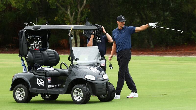 Tom Brady celebrates after holing out for a birdie on the seventh hole. Photograph:Mike Ehrmann/Getty