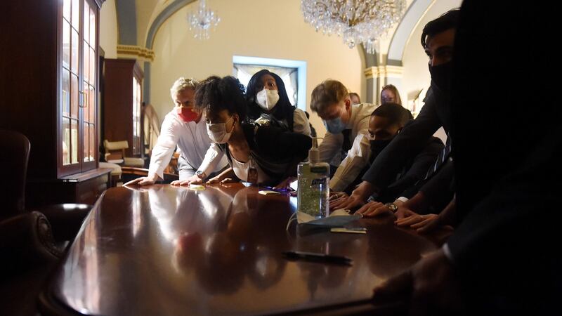 Congress staffers barricade themselves into a room in the US Capitol. Photograph: Olivier Douliery/AFP via Getty Images