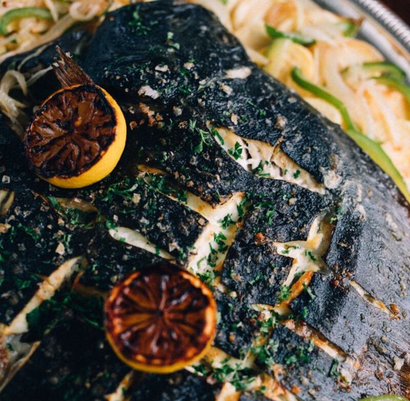 Roasted turbot on the bone with confit potatoes, peppers and onions